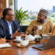 Business professionals building trust over tea during an Africa market entry strategy meeting.