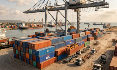 Cargo containers stacked at an African seaport, the point where predictable shipping costs end for landlocked exporters.