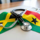 Jamaican and Ghanaian flags, bound with a stethoscope symbolizing the bilateral nurse recruitment agreement between Jamaica and Ghana.