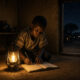 Child studying by lamplight in a rural African village without electricity
