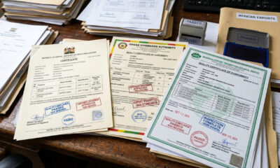Close-up of conformity assessment certificates and quality compliance stamps for African manufactured exports.