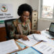 African small business owner reviewing cross-border trade finance documents, reflecting AfCFTA trade barriers