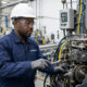 Industrial maintenance technician repairing machinery to protect manufacturing investments and prevent costly production downtime.