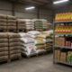 Cement bags, cooking oil, and packaged foods stacked in an African warehouse, representing the everyday staples behind Africa’s boring businesses.