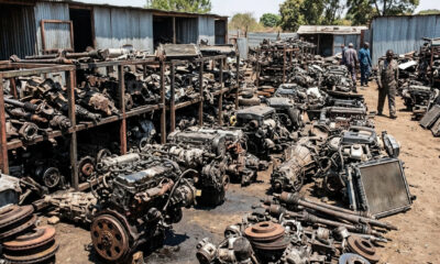 Salvaged vehicle parts and used engines stacked in an African spare-parts yard