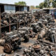 Salvaged vehicle parts and used engines stacked in an African spare-parts yard