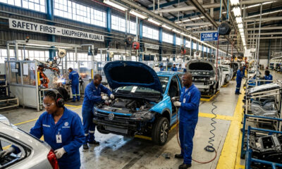 Workers assemble vehicles on a South African car factory floor as SKD subsidies end.