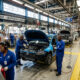 Workers assemble vehicles on a South African car factory floor as SKD subsidies end.