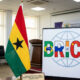 Ghanaian flag next to the BRICS alliance logo, representing Ghana's formal cabinet-approved application to join the bloc.